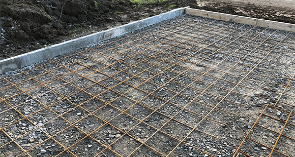 the foundation of a house being laid on the ground