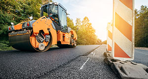 a Vibratory asphalt rollers compactor compacting a freshly laid tarmac road