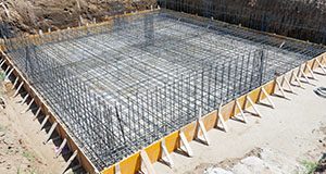 the laid foundation of a house in a dug out hole