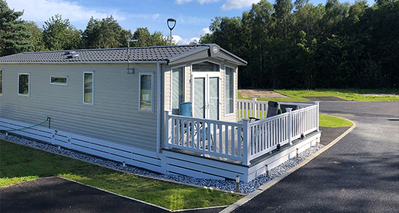 a newly tarmacked road leading to a holiday caravan